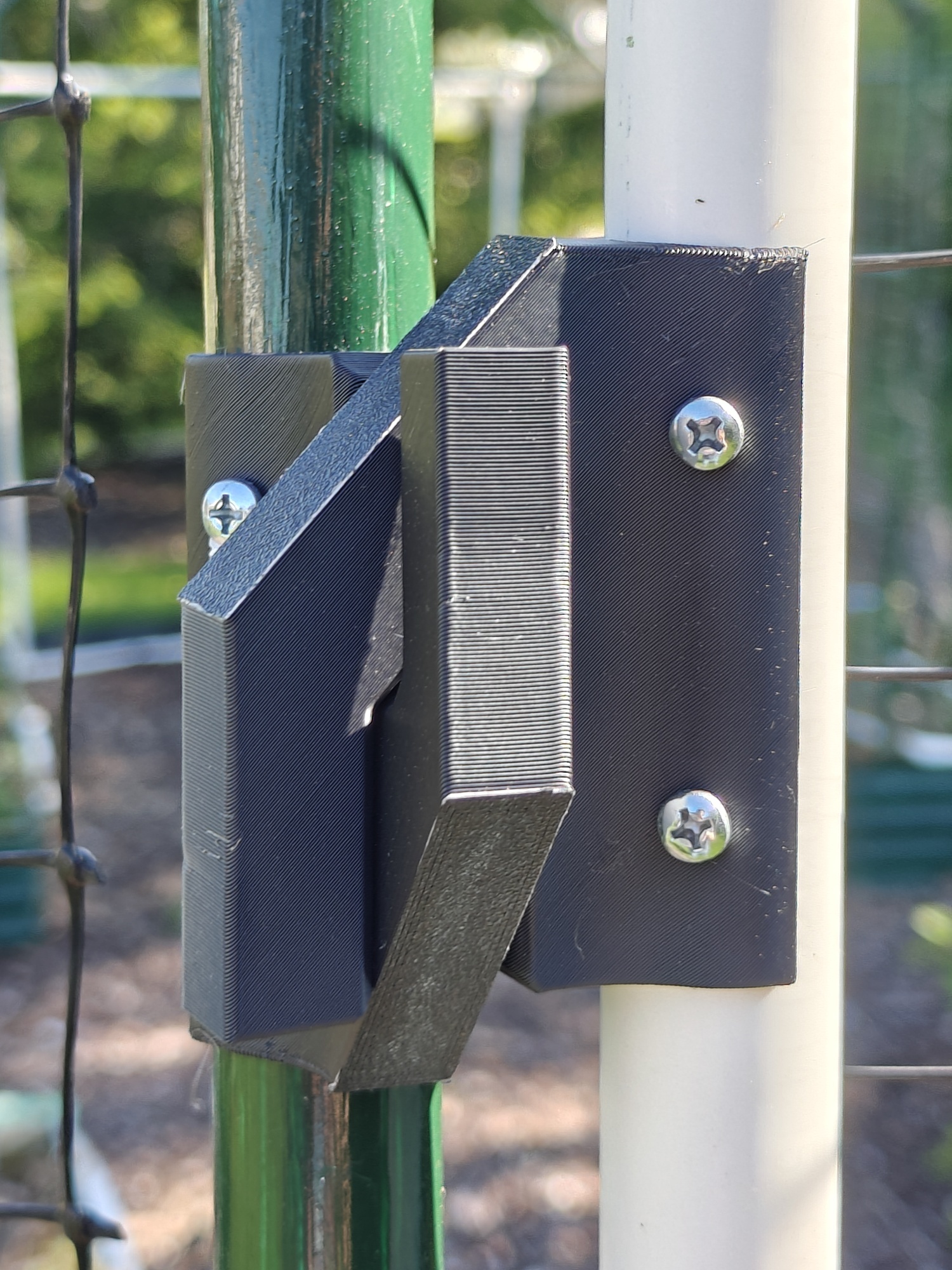 A 3D printed part holds a PVC garden gate to a fence